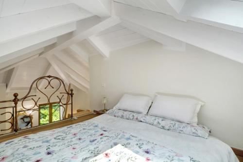 a bedroom with a bed in a attic at Cà Du Praettu in Albisola Superiore