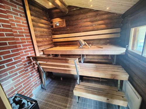 an empty room with a sink and benches in a cabin at Cabin Pikku Saana in Kilpisjärvi