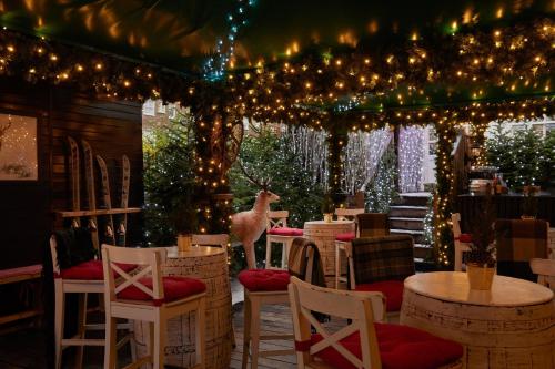 a restaurant with lights and chairs and tables and tablesktop at The Montague On The Gardens in London