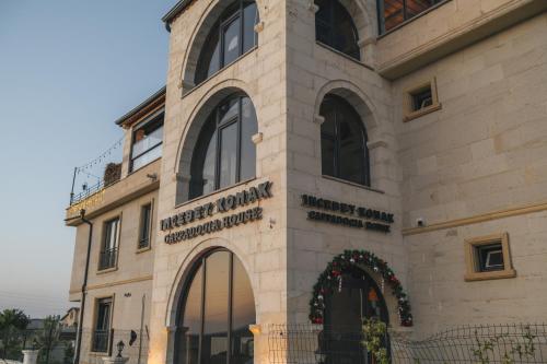 a building with a sign on the side of it at İncebey Konak Cappadocia in Uçhisar