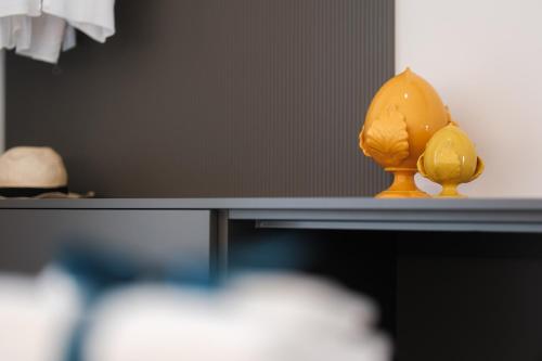 a figurine of a lemon sitting on a table at Eleia Mirea in Monopoli
