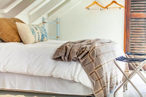 a bedroom with a bed with a blanket on it at Sea Castle's Paternoster in Paternoster