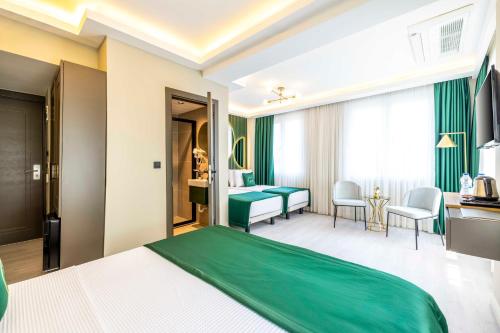 a hotel room with a green bed and a desk at Sistina Old City Hotel in Istanbul