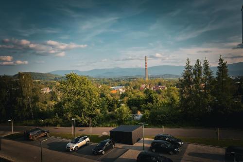a parking lot with cars parked in a parking lot at M&D apartamenty w Karkonoszach! 2 sypialnie, salon z aneksem, balkon z widokiem na góry in Jelenia Góra