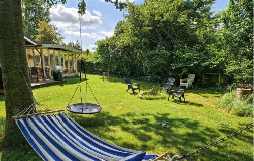 a hammock in a yard next to a house at 2 Bedroom Awesome Home In Farsø in Farsø