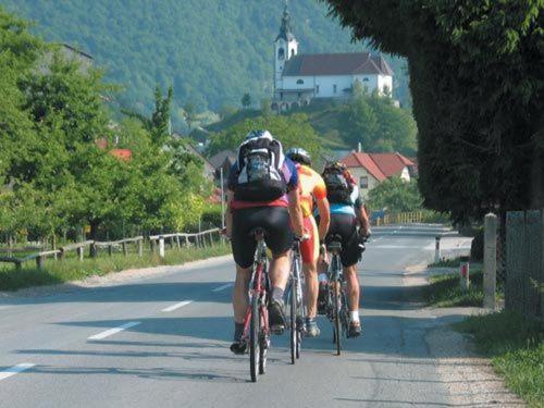 a group of people riding bikes down a road at Appartement Rozika in Slovenj Gradec