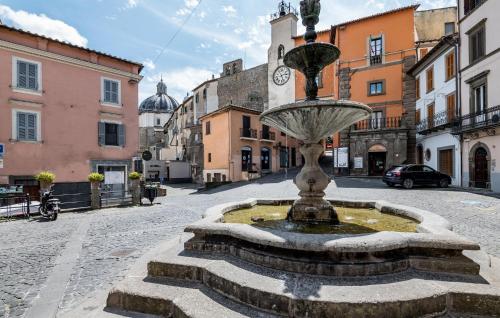 a fountain in the middle of a city street at Amazing Home In Montefiascone in Montefiascone