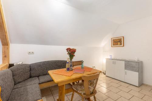 a living room with a couch and a table at Ferienwohnung Sonnenblume in Rhadern