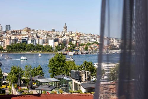 a view of a river and a city with boats at Sistina Old City Hotel in Istanbul