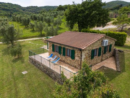 an aerial view of a stone house with two lounge chairs at Poggio Diavolino - Suvereto in Suvereto