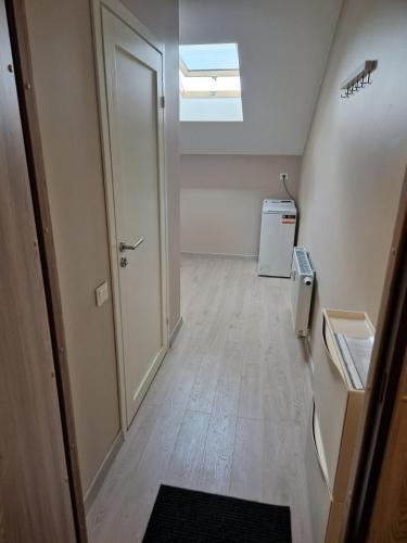 an empty hallway with a door and a window at FB Apartamentai in Plungė