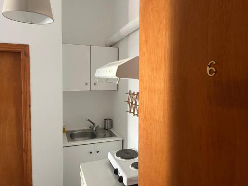 a small kitchen with a sink and a stove at Ermou Studios in Loutra Edipsou