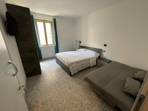 a small bedroom with a bed and a window at angolo verde in Terni