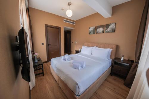 a bedroom with a white bed with two pillows on it at Servi House - Trabzon in Trabzon