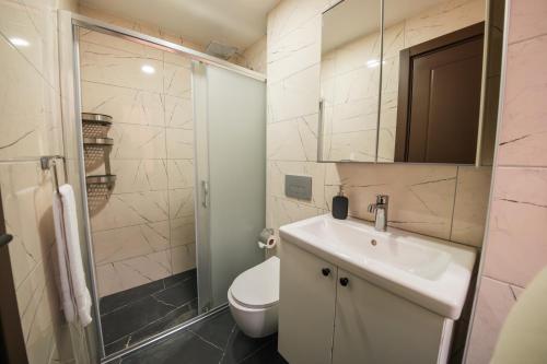 a bathroom with a toilet and a sink and a shower at Servi House - Trabzon in Trabzon