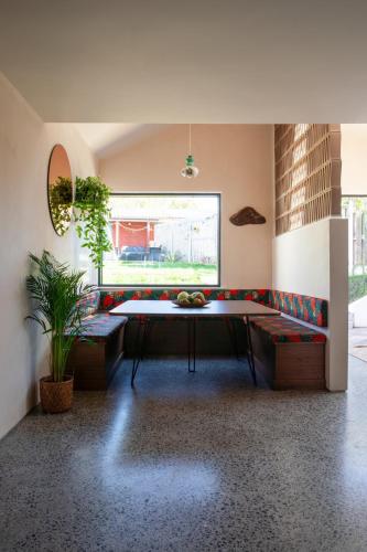 a living room with a table and a couch at Stylish Dublin Coastal Home As Seen on TV in Donabate