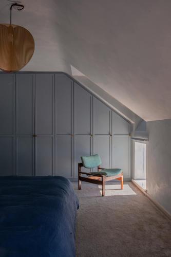 a bedroom with a bed and a chair at Stylish Dublin Coastal Home As Seen on TV in Donabate