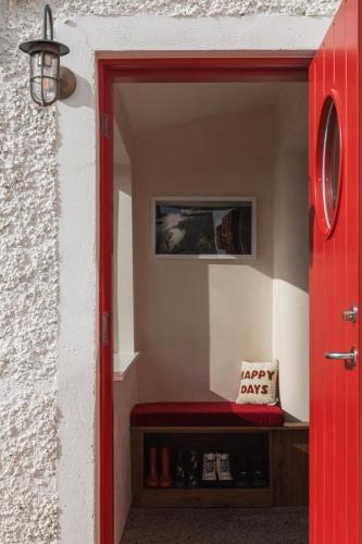 a red door with a happy sign on it at Stylish Dublin Coastal Home As Seen on TV in Donabate