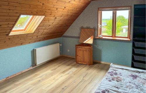a attic room with a bed and two windows at 3 Bedroom Cozy Home In Store Heddinge in Store Heddinge