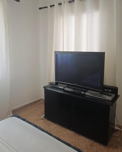 a flat screen tv sitting on a dresser in a bedroom at Constantina D Apt Argos in Argos