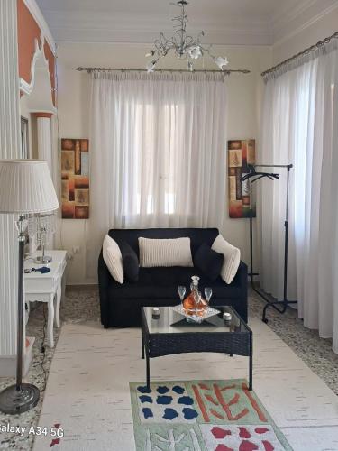 a living room with a blue couch and a table at Constantina D Apt Argos in Argos