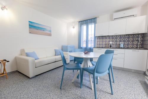 a kitchen and a living room with a table and chairs at Zeus Atabyrios 3 - Open Space in Agrigento