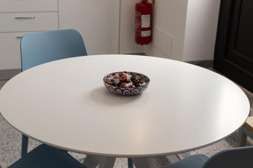 a bowl sitting on top of a white table at Zeus Atabyrios 3 - Open Space in Agrigento