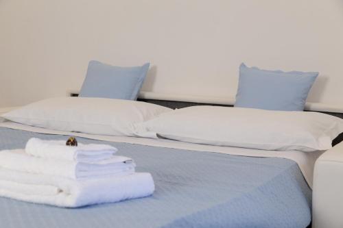 a bed with towels and pillows on it at Zeus Atabyrios 3 - Open Space in Agrigento