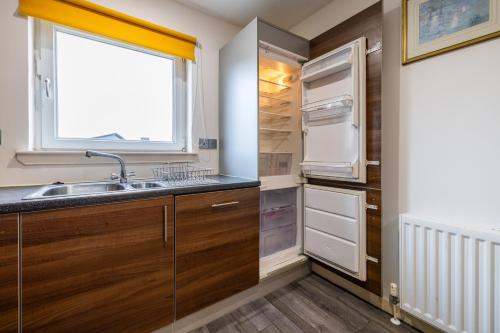 a kitchen with a sink and a window at Dundee City centre apartment - 3 bedrooms sleeps 6 in Dundee