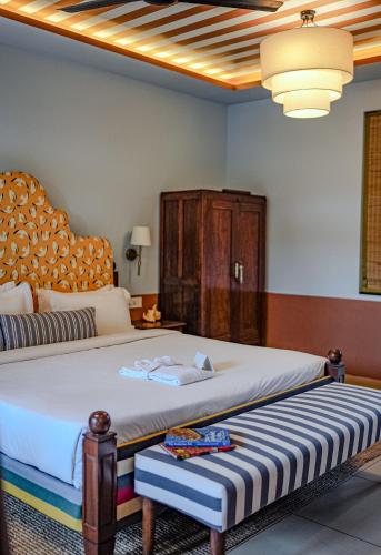 a bedroom with a large bed with a wooden headboard at The Project Cafe and Hotel in Aldona