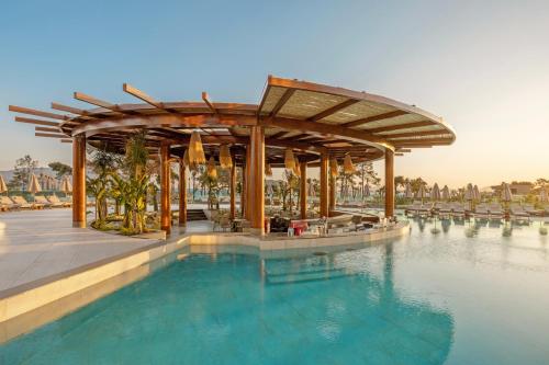 a swimming pool with a wooden pavilion next to a swimming pool at Liberty Signa in Fethiye