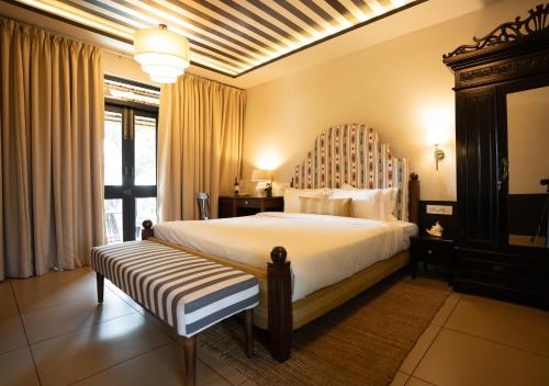 a bedroom with a large bed and a large window at The Project Cafe and Hotel in Aldona