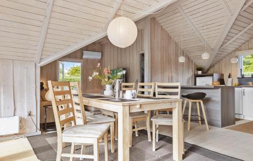 a kitchen and dining room with a wooden table and chairs at Awesome Home In Hejls With Wifi in Hejls