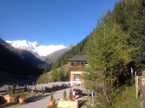 a building on the side of a mountain with snow at Berghaus Außergschlöß in Matrei in Osttirol