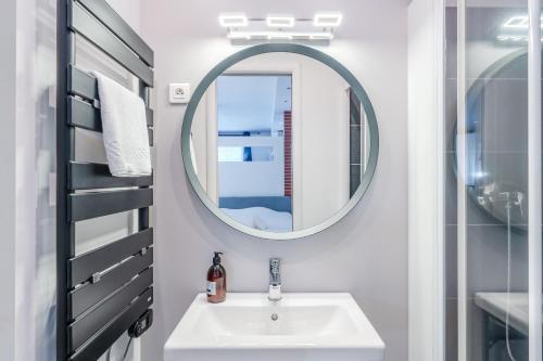 une salle de bain avec un lavabo et un miroir dans l'établissement Loft Lamoricière - 15 minutes à pieds du centre, à Nantes