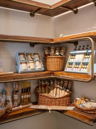 a shelf filled with wicker baskets and other items at The Project Cafe and Hotel in Aldona