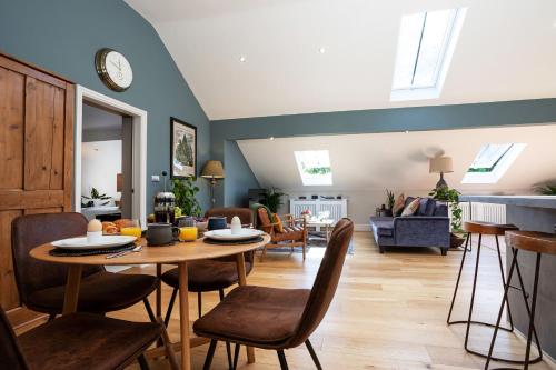 a dining room and living room with a table and chairs at Bowland Lodges in Lancaster