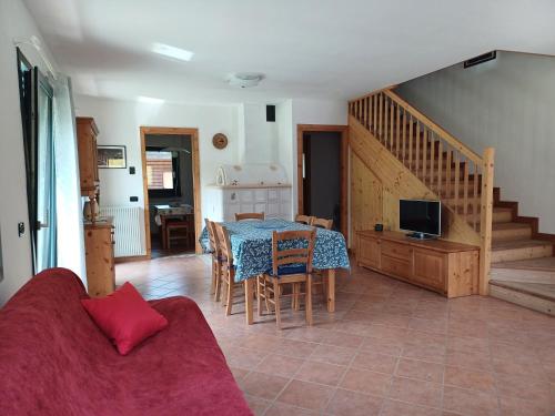 a living room with a table and a couch at La Casa di Adele in Pieve di Cadore