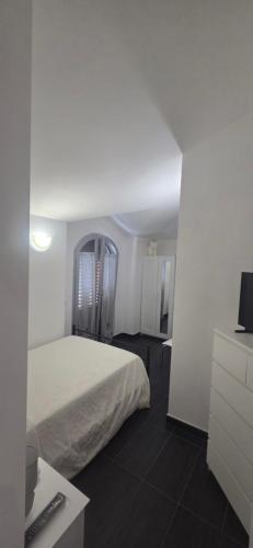 a bedroom with a bed and a desk with a computer at Appartamento in villa Gra&Mary in San Giovanni in Marignano