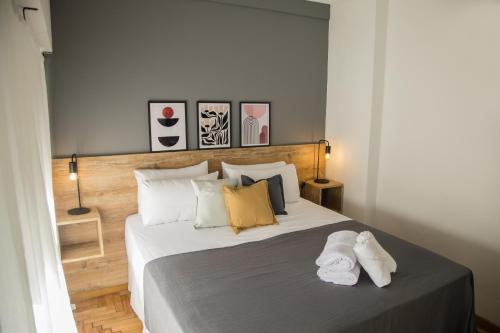 a bedroom with a bed with two towels on it at El Misti Suites Buenos Aires in Buenos Aires