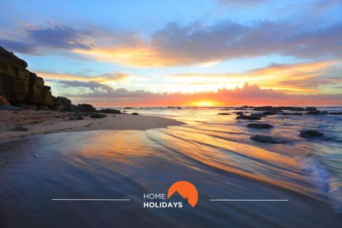 a picture of a beach with a sunset at #313 Travessa dos Arcos by Home Holidays in Albufeira