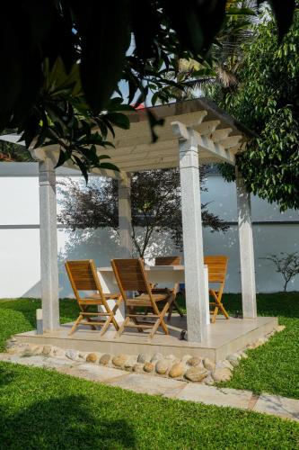 a table and chairs under a gazebo at Casa de Amor Home Of Love in Ambalavayal