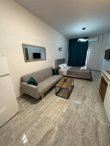 a living room with a couch and a table at NATALIE'S APARTMENTS in Mákri