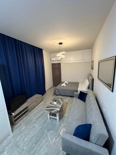 a living room with a couch and a table at NATALIE'S APARTMENTS in Mákri