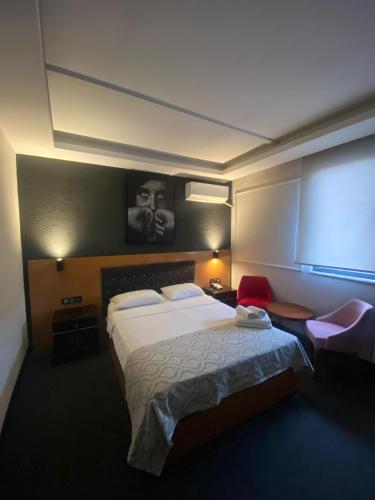 a hotel room with a large bed and a window at Samsun Osmanlı Otel in Samsun