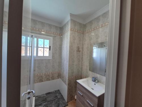 a bathroom with a tub and a sink and a shower at Uc Villa in Málaga