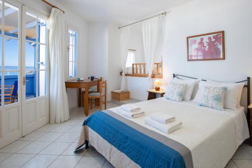 a bedroom with a bed with towels on it at Pantazis Studios in Agios Nikitas in Agios Nikitas