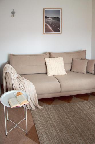 a living room with a couch and a chair at Apartamenty Tercet, Apartament Kwartet, Apartament DUO in Ustka