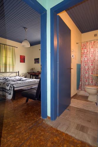 a bedroom with a bed and a bathroom with a toilet at Villa Helios in Kandia