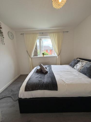 a bedroom with a large bed and a window at The Olive Villa in Manchester